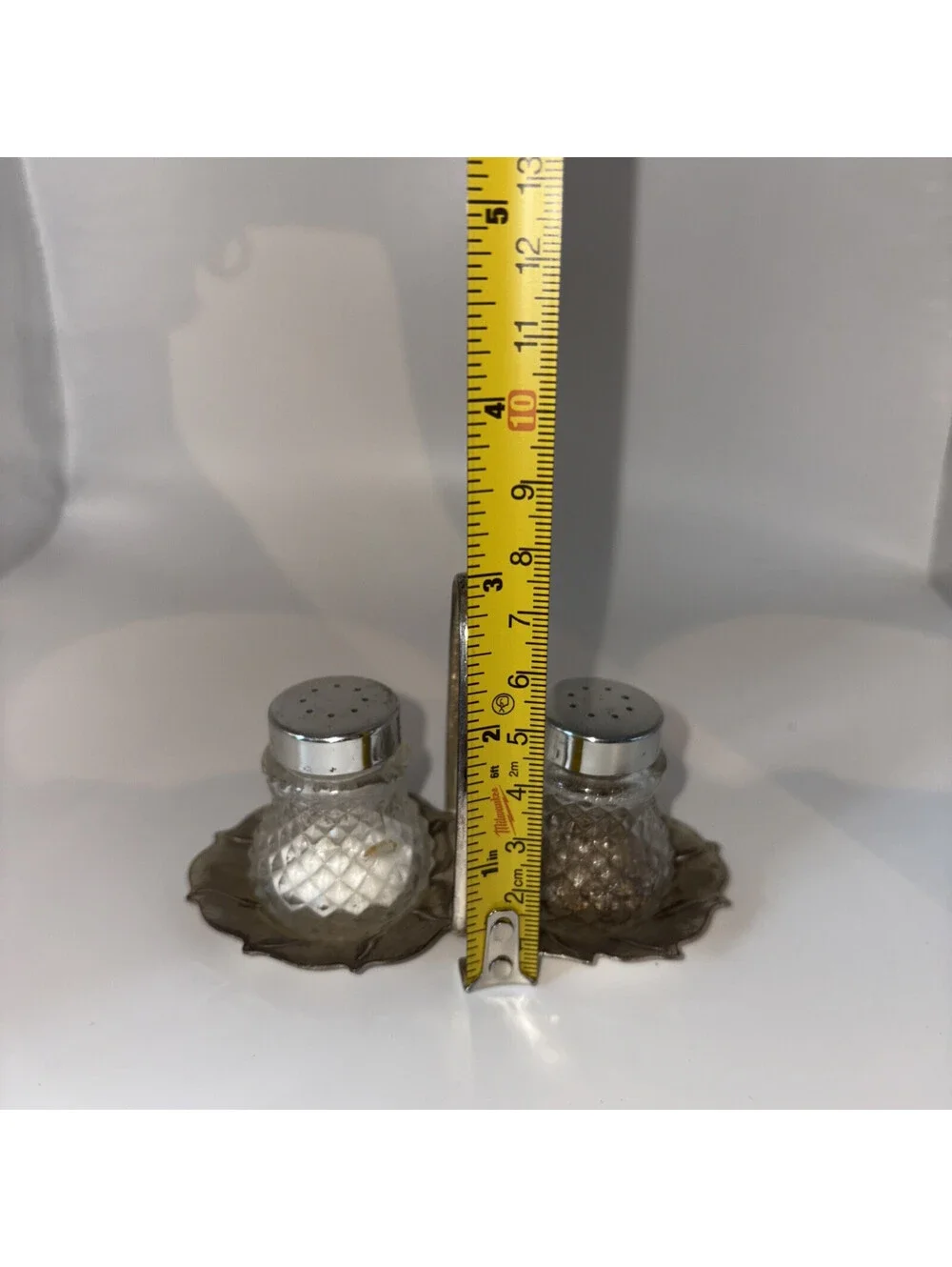 Miniature glass salt and pepper shakers with chrome lids and base holder
